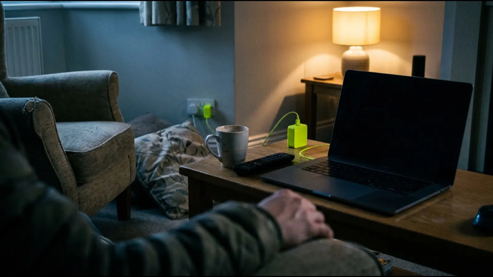 A laptop on a living-room coffee table in the evening